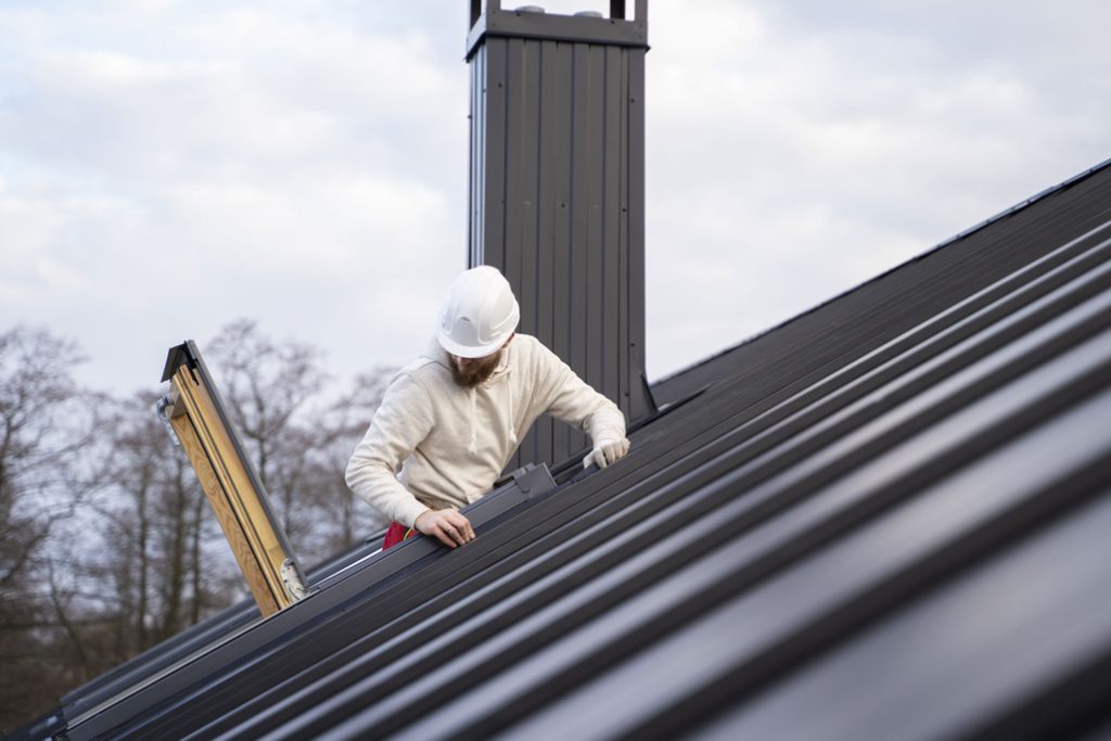 Roofing company installing a metal roofing system